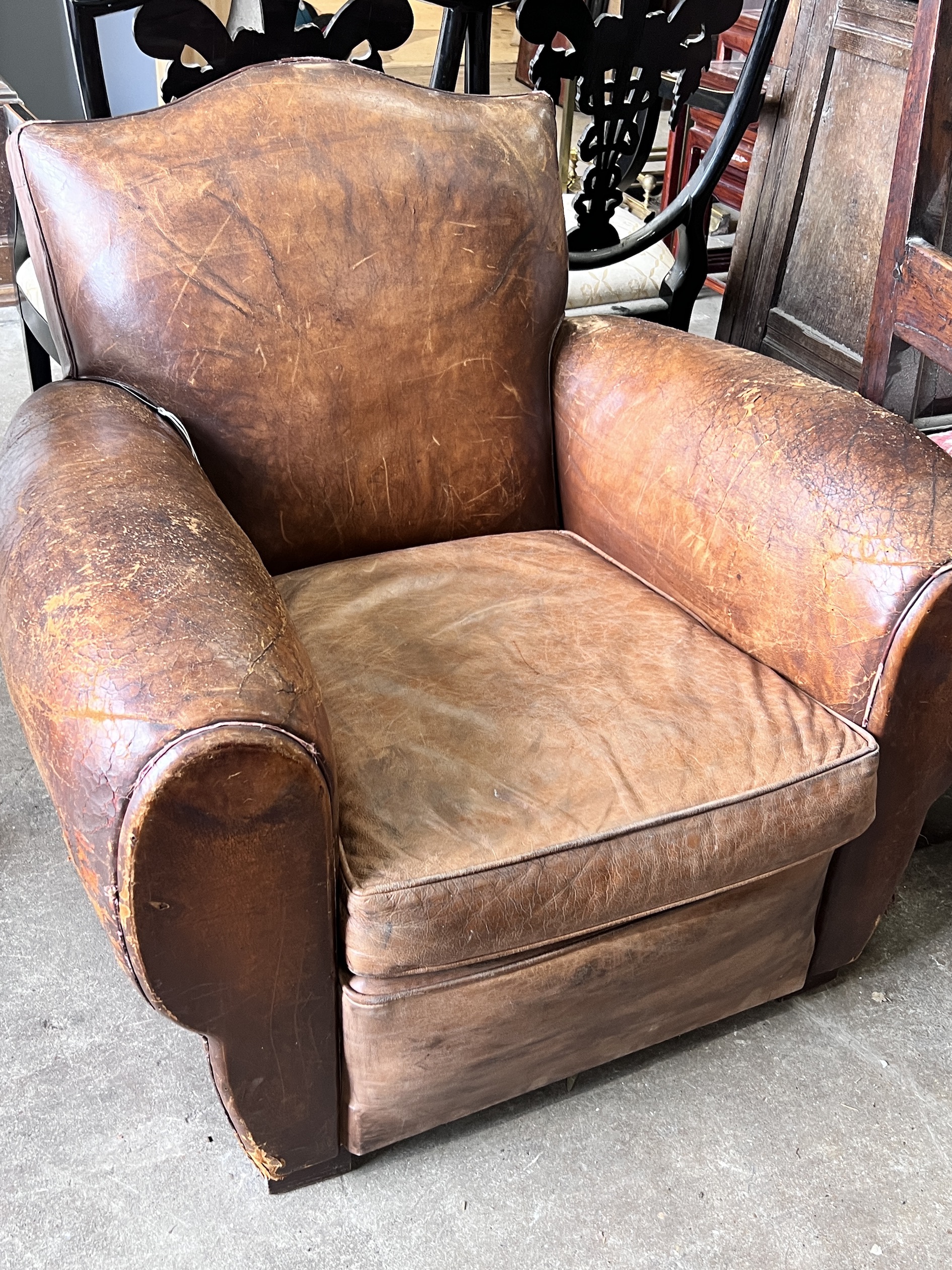 A mid century French tan leather club chair, width 94cm, depth 84cm, height 80cm